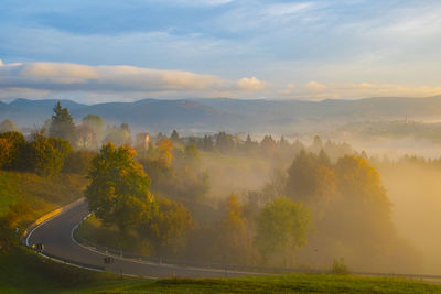 Scenic view of landscape against sky during foggy weather