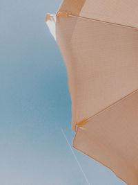 Low angle view of beach against clear blue sky