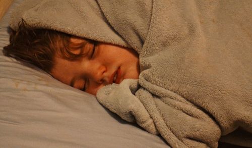 Close-up of boy sleeping in bed