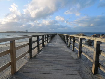 Pier over sea against sky