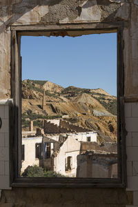 Buildings in city against clear sky