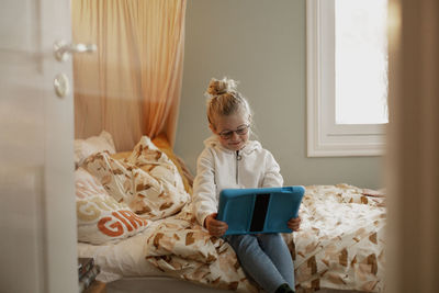 Woman holding mobile phone at home