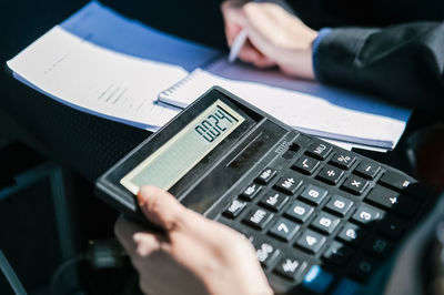 Midsection of person using mobile phone