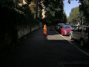 Rear view of woman walking on road