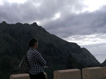 Man standing on mountain against sky