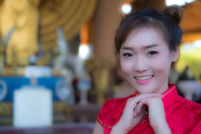 Close-up portrait of smiling young woman