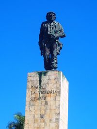 Low angle view of statue against clear blue sky