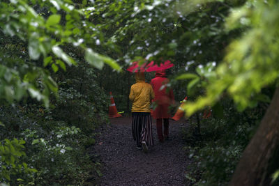 Rear view of people walking outdoors