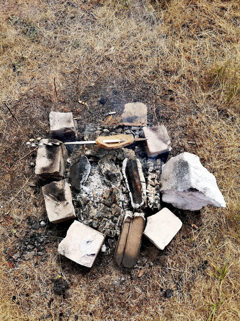 land, high angle view, field, no people, day, nature, outdoors, directly above, environmental issues, solid, tree, burnt, close-up, wood - material, garbage, wood, group of objects, abandoned, grass, group, pollution