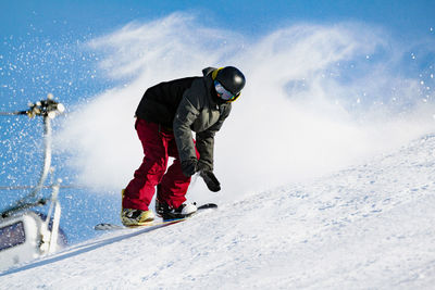 Rear view of man with snow on mountain