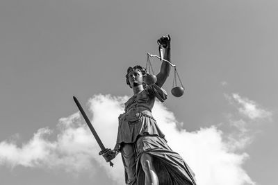 Low angle view of statue against sky