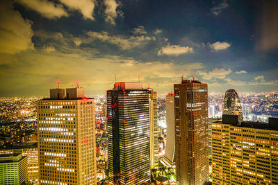 Illuminated cityscape against sky at night