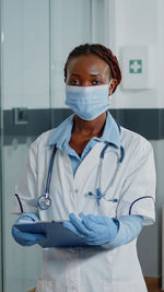 Portrait of female doctor examining x-ray at clinic