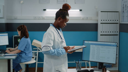 Doctor looking at digital tablet at clinic