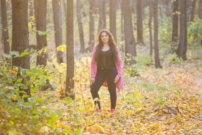 Full length portrait of woman in forest