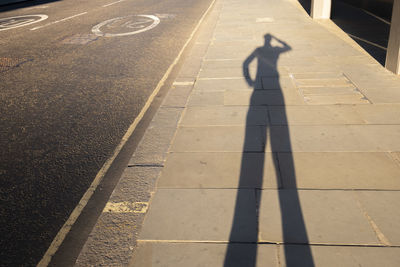 High angle view of man shadow on street