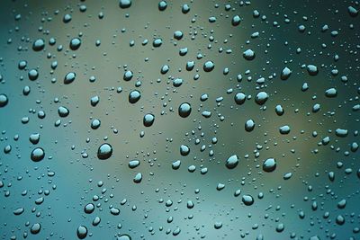 Full frame shot of wet glass window during rainy season