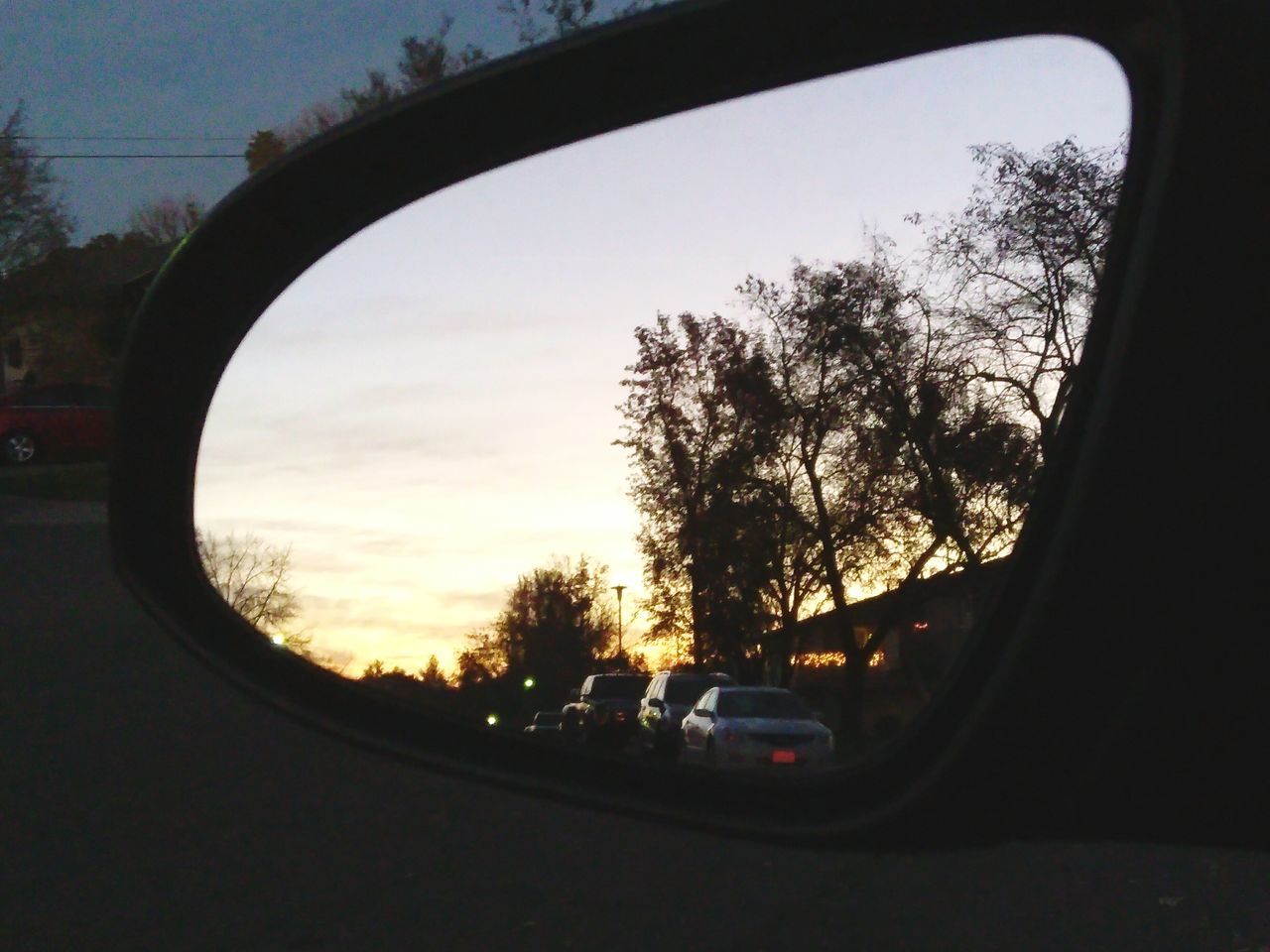 CLOSE-UP OF SIDE-VIEW MIRROR AGAINST SKY