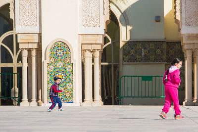 Woman walking on street amidst buildings