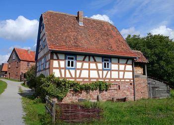 Houses against cloudy sky