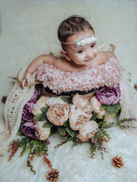 Portrait of smiling young woman with bouquet