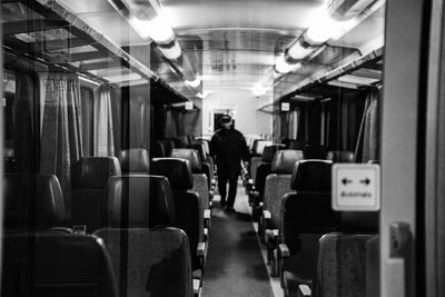 Rear view of man walking in train