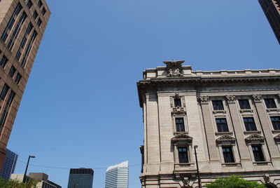 Low angle view of buildings against blue sky