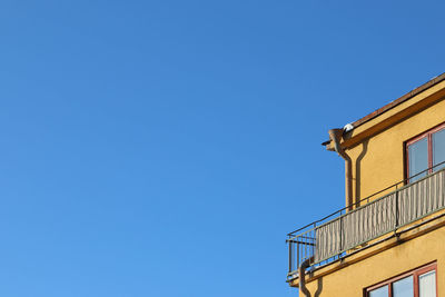 Low angle view of building against clear blue sky