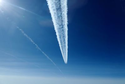 Low angle view of vapor trail in blue sky