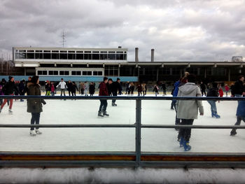 People against cloudy sky