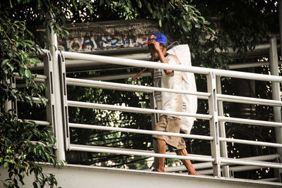 Man standing by railing