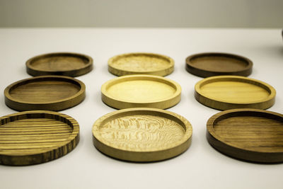 Close-up of wooden plates on white background