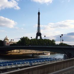 Eiffel tower against cloudy sky