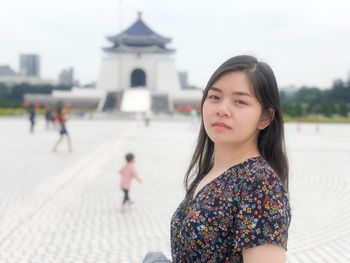 Portrait of woman standing in city