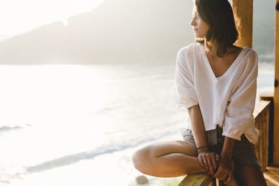 Young woman sitting on beach