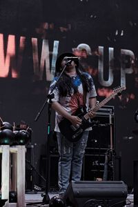 Man singing while playing guitar