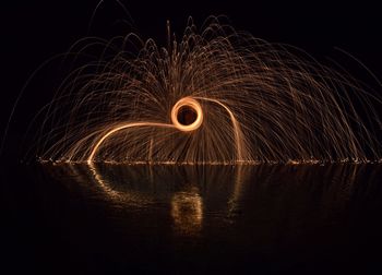 Wire wool by lake at night