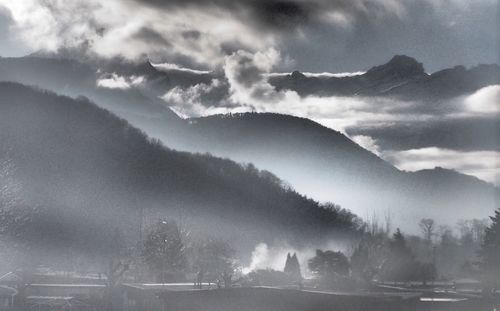 Scenic view of mountains against cloudy sky