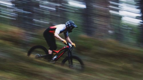 Blurred motion of man riding bicycle