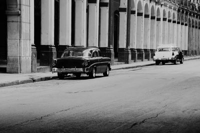 Cars parked on road by buildings