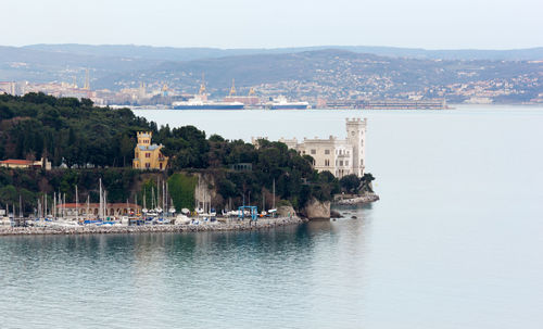 Scenic view of sea and buildings against sky