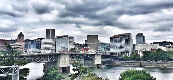 View of cityscape against cloudy sky