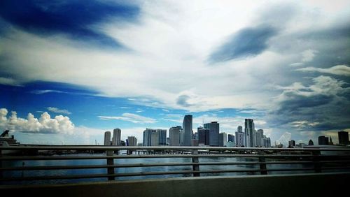 View of cityscape against cloudy sky