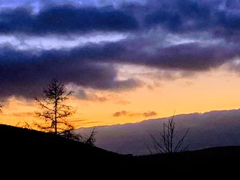 Scenic view of silhouette landscape against dramatic sky