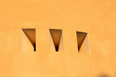 Low angle view of yellow wall