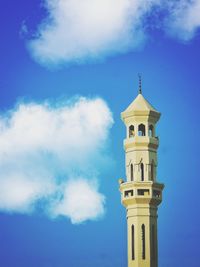 Low angle view of tower and building against sky