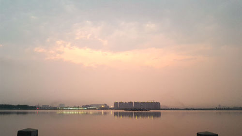 Scenic view of lake against sky during sunset