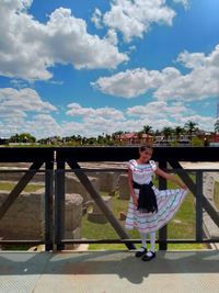 Full length of girl standing against sky