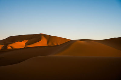 Scenic view of desert against clear sky