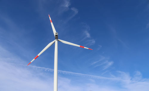 Low angle view of windmill against sky